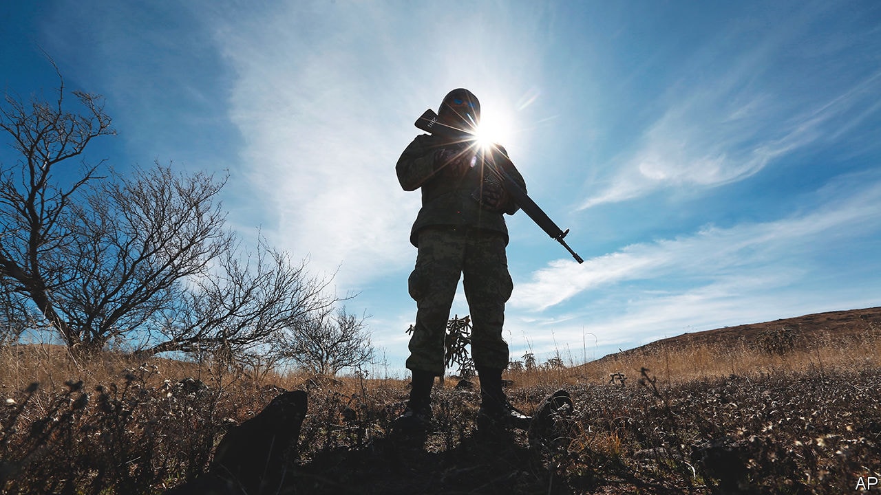 FILE - A National Guards soldier stands guard near Bavispe, Sonora state, Mexico, where family members of the extended LeBaron family were ambushed by gunmen last year, one day before the expected arrival of Mexican President Andres Manuel Lopez Obrador, Jan. 11, 2020. Lopez Obrador has begun exploring plans to side-step congress to hand formal control of the National Guard to the army. That has raised concerns, because he won approval for creating the force in 2019 by pledging in the constitution that it would be under nominal civilian control and that the army would be off the streets by 2024. (AP Photo/Christian Chavez, File)